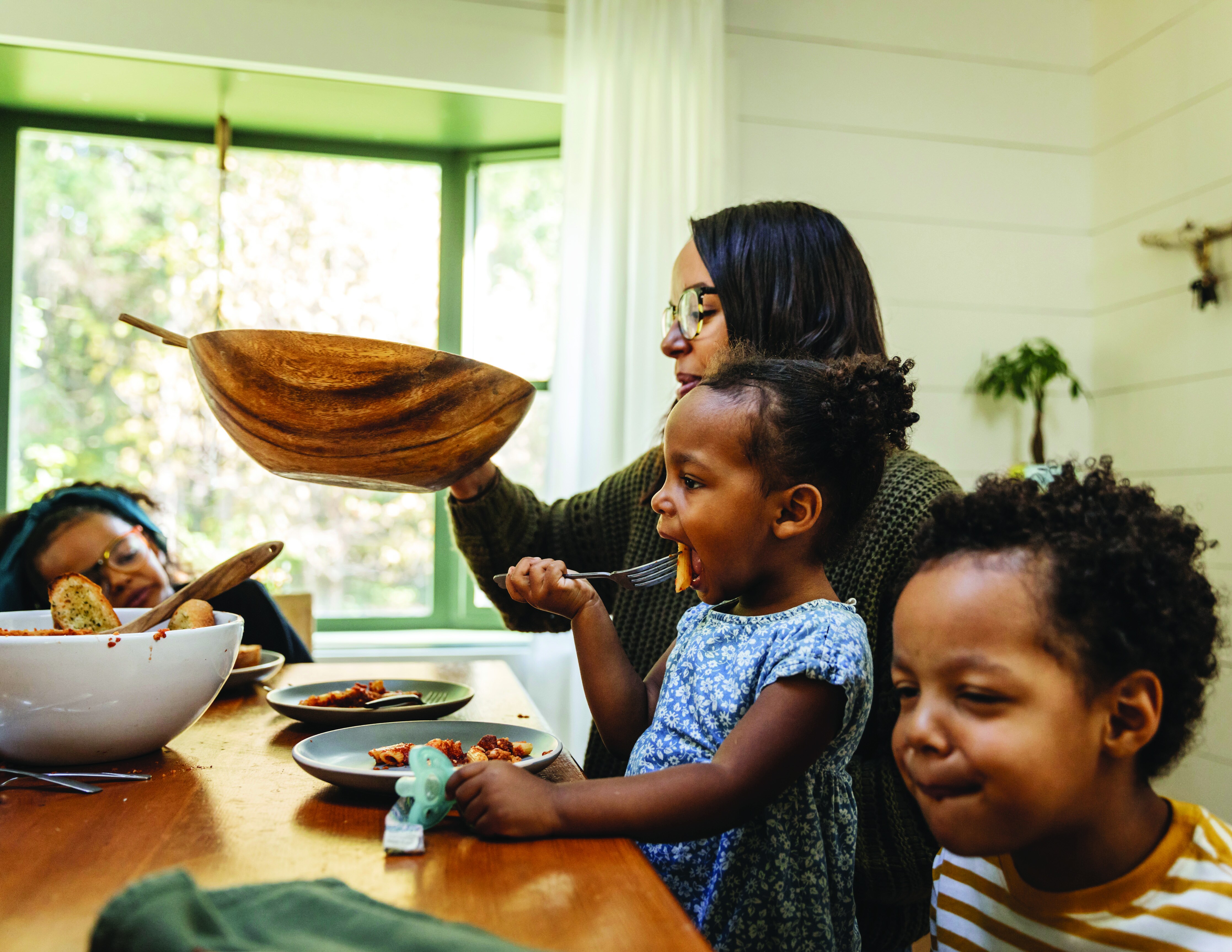 A family sharing a meal with young children